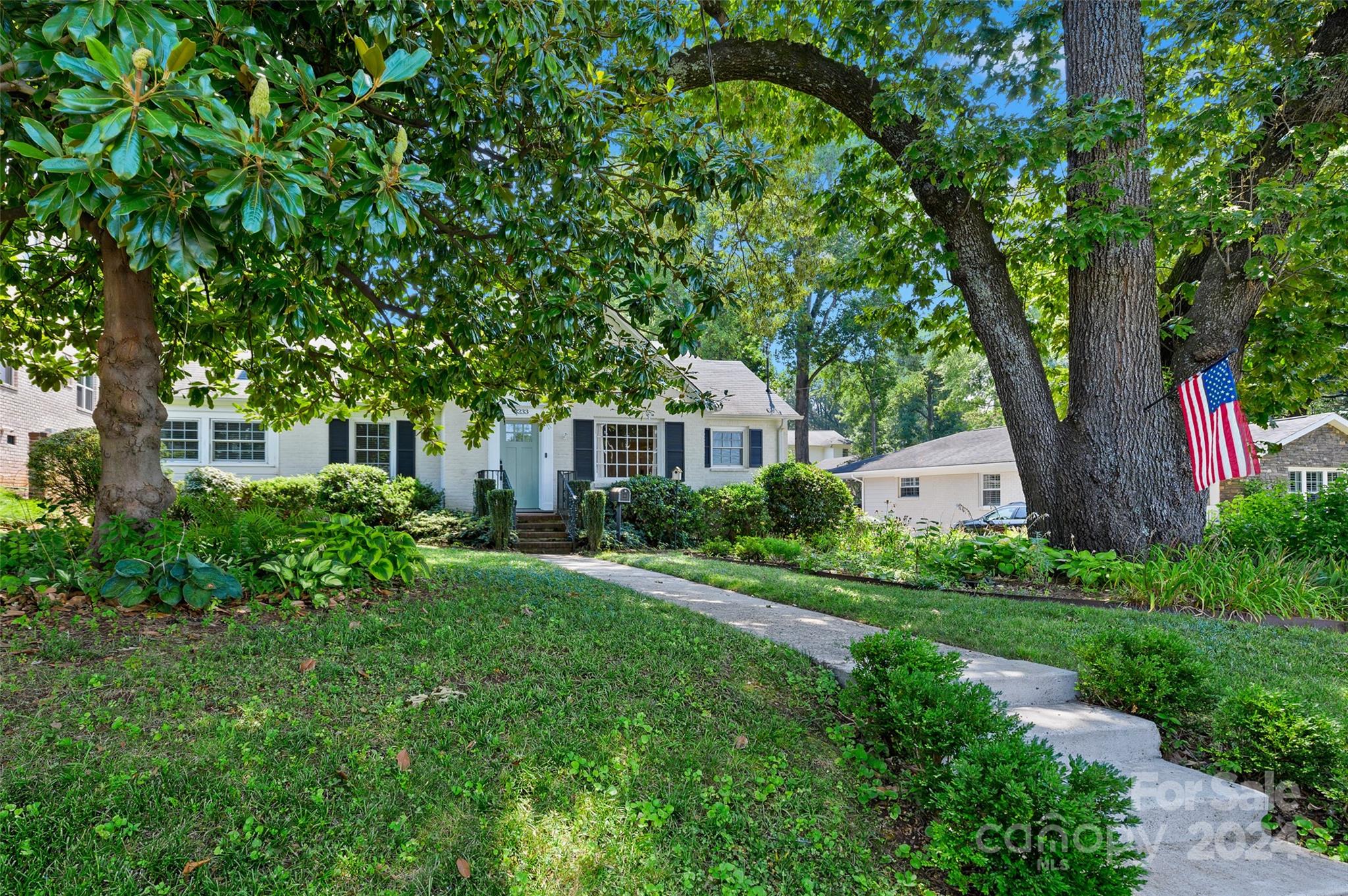 3233 Pinehurst Place Charlotte, NC 28209 - Photo 32 of 39 a front view of a house with garden