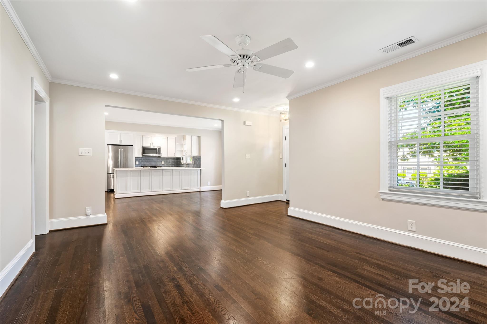 3233 Pinehurst Place Charlotte, NC 28209 - Photo 7 of 39 a view of an empty room with wooden floor and a window