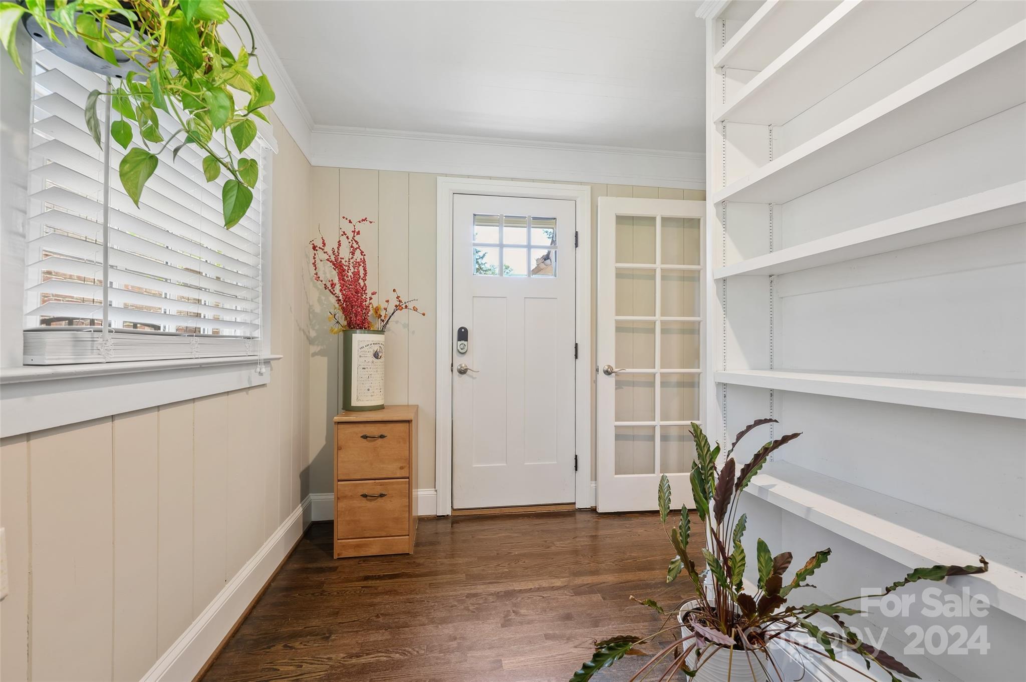 3233 Pinehurst Place Charlotte, NC 28209 - Photo 9 of 39 a view of a hallway with wooden floor and a potted plant