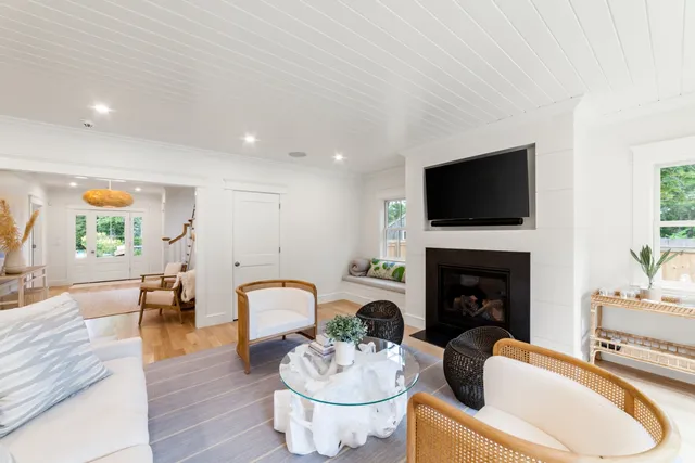 a living room with furniture a fireplace and a flat screen tv