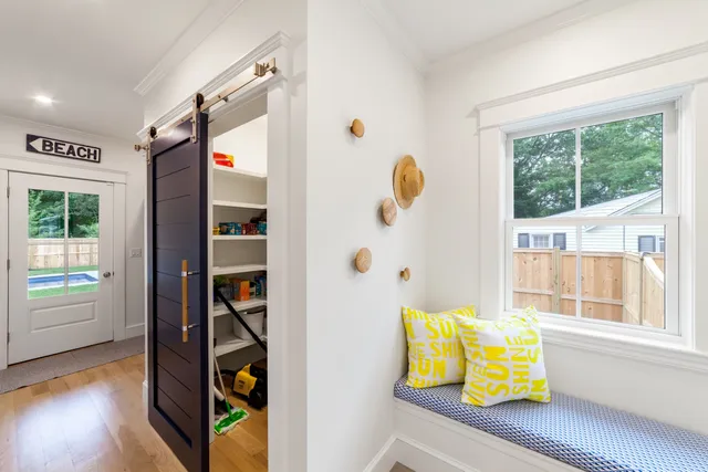 a view of front door with wooden floor and windows
