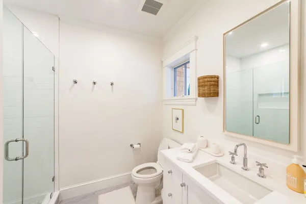 a bathroom with a sink toilet and shower