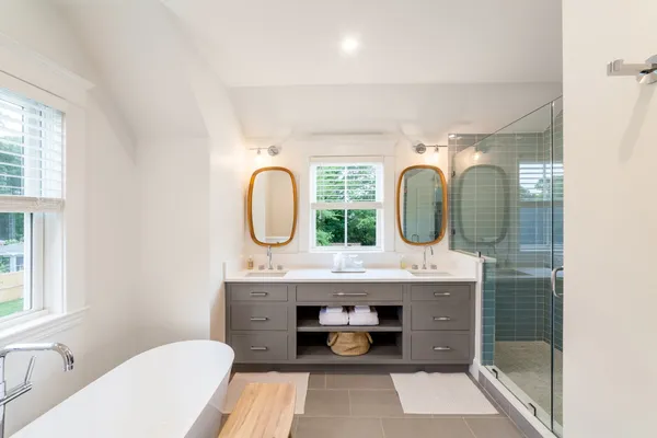 a bathroom with a granite countertop toilet a sink and a mirror