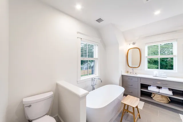 a bathroom with a toilet a sink and a mirror