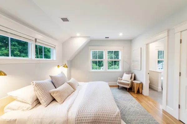 a bedroom with a bed and a large window