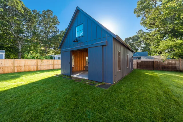 a view of backyard with barn and a yard