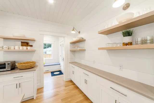 a spacious bathroom with a sink and a wooden floor