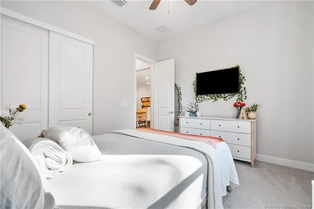a bedroom with a bed and flat screen tv