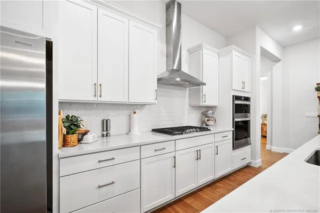 a living room with fireplace furniture and a wooden floor
