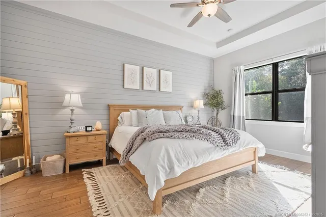 a spacious bedroom with a bed and window