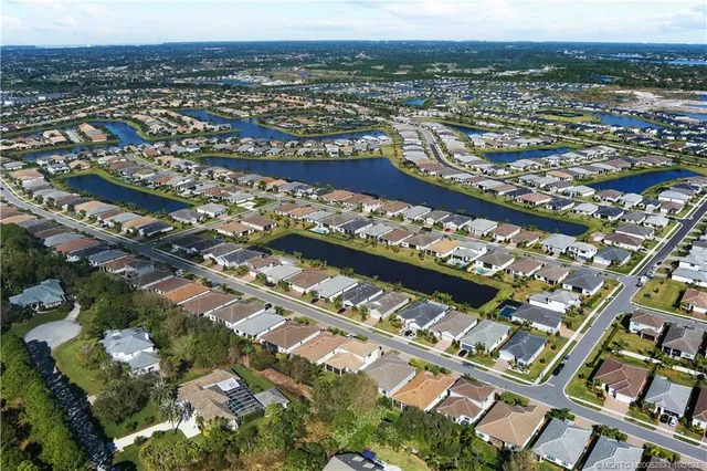 an aerial view of a swimming pool with outdoor seating