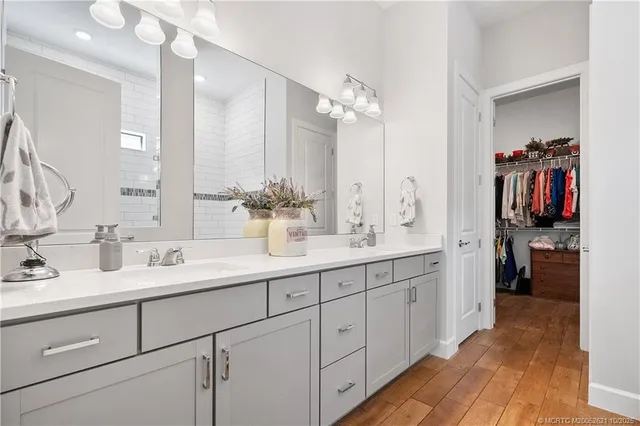 a en suite bathroom with double sink and a mirror