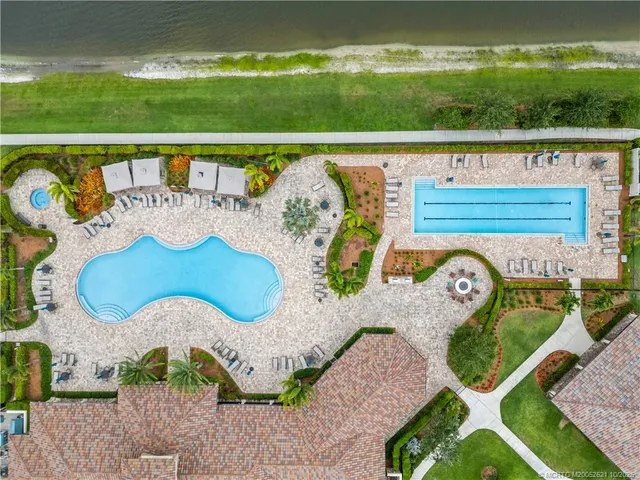 a view of swimming pool with a garden and seating area