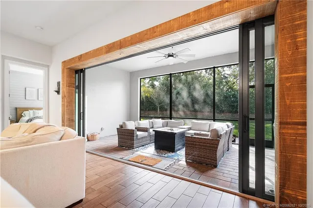 a living room with furniture and a floor to ceiling window