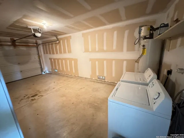 a view of empty room with kitchen