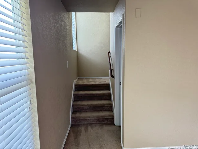 a view of a hallway with stairs