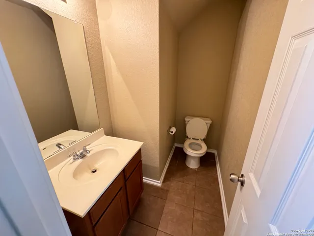 a bathroom with a sink a toilet and a window