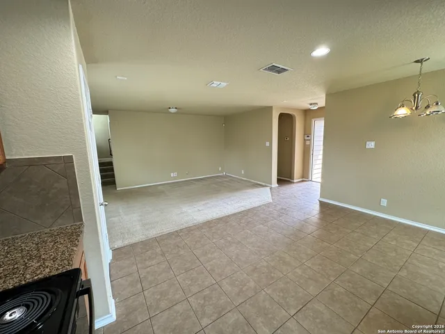 a view of an empty room with windows