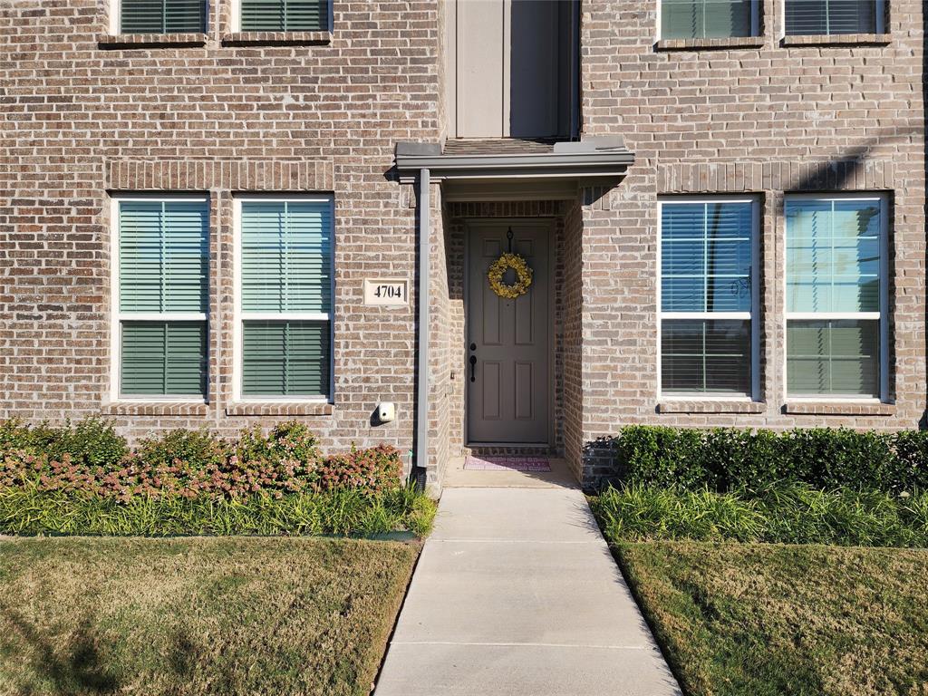 4704 Haltom Road Haltom City, TX 76117 - Photo 1 of 28 View of exterior entry with brick siding and a yard