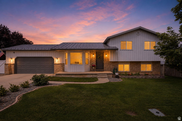 Exterior featuring a metal roof, two-tone siding, and a stone facade