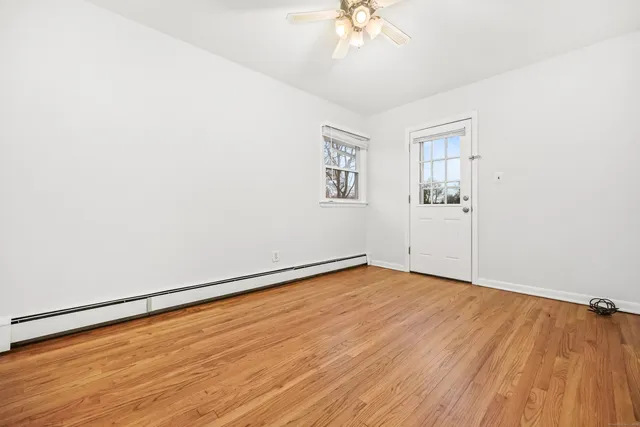 wooden floor in an empty room with a window