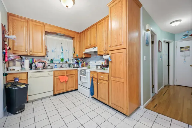 a kitchen with stainless steel appliances granite countertop a refrigerator and a stove top oven