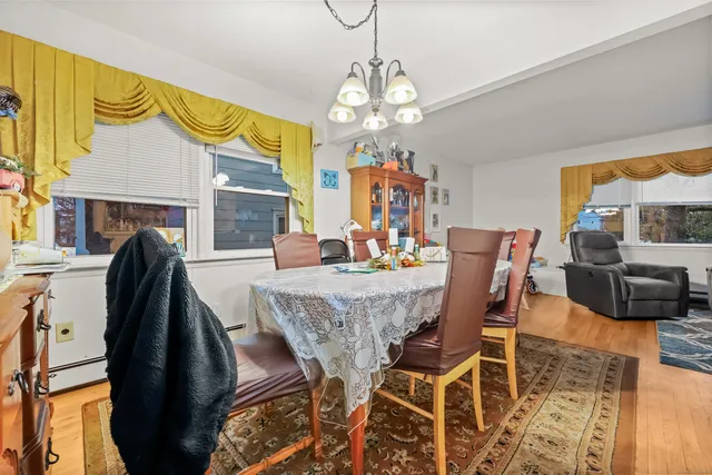 a view of a dining room with furniture and a chandelier