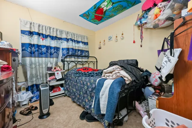 a bed room with a bed and a desk