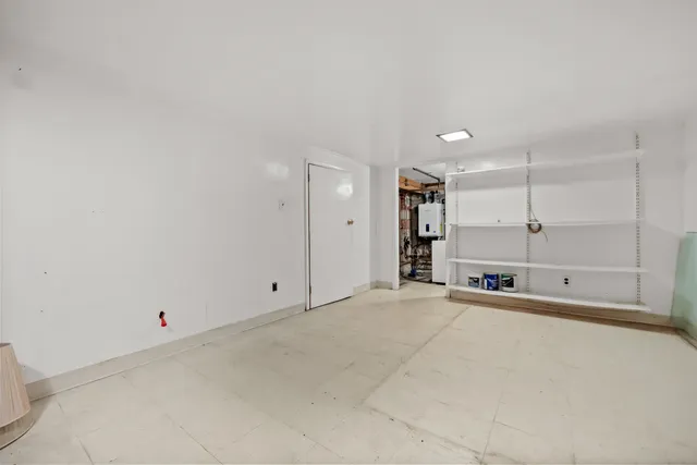 a view of an empty room with a kitchen