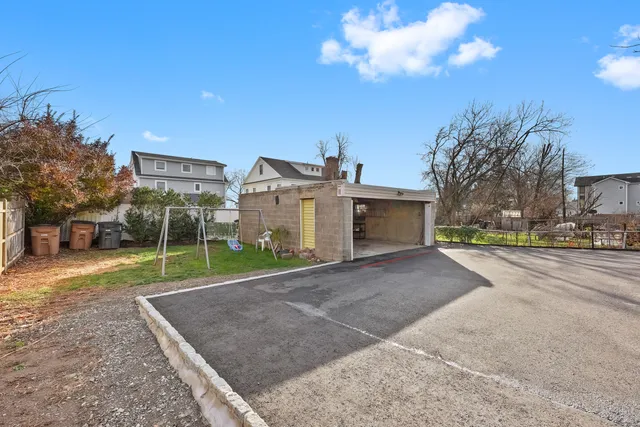a view of a house with a yard and garage
