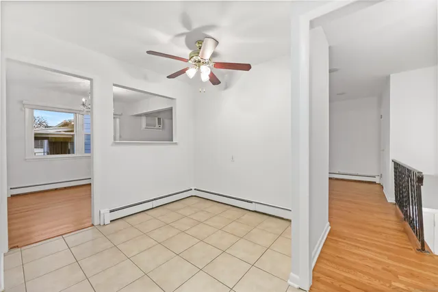 a view of a hallway with wooden floor and closet