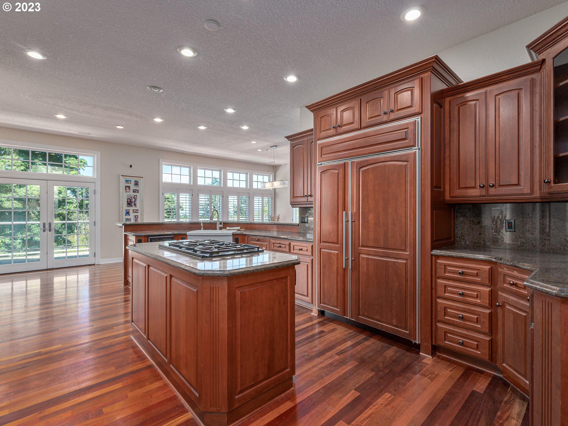 565 Southeast 46th Drive Gresham, OR 97080 - Photo 13 of 48 a kitchen with kitchen island granite countertop wooden cabinets and a stove