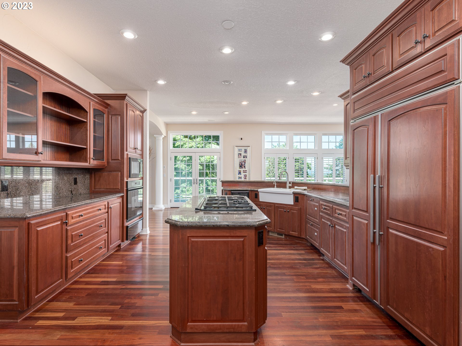565 Southeast 46th Drive Gresham, OR 97080 - Photo 15 of 48 a kitchen with stainless steel appliances granite countertop a refrigerator a stove top oven and wooden floors