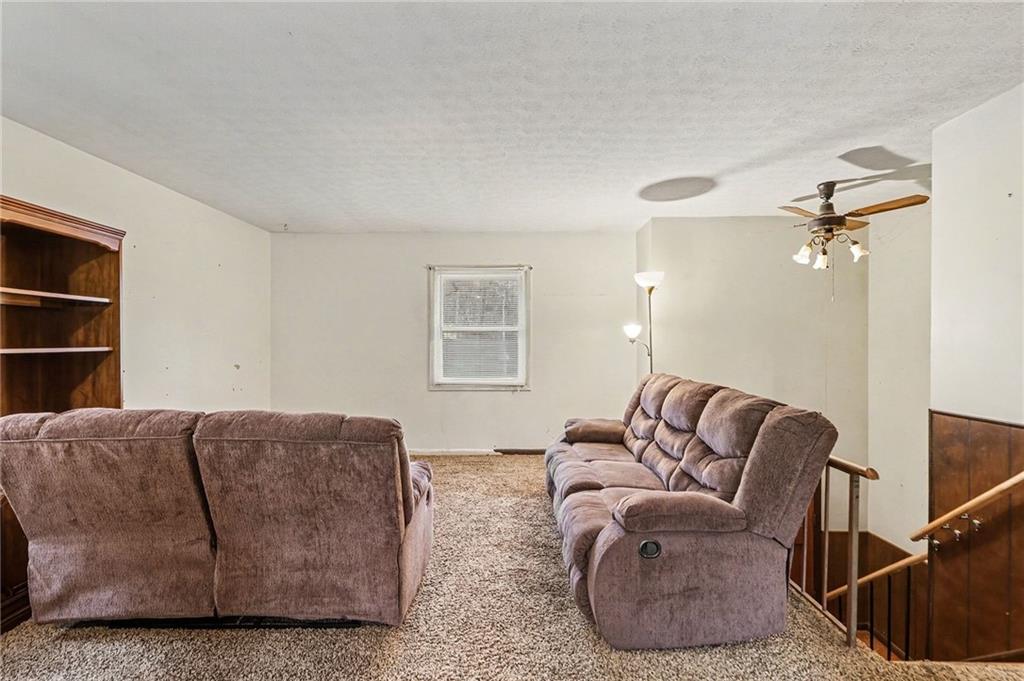 91 Berlin Street Tallapoosa, GA 30176 - Photo 12 of 25 a living room with furniture a ceiling fan and a window