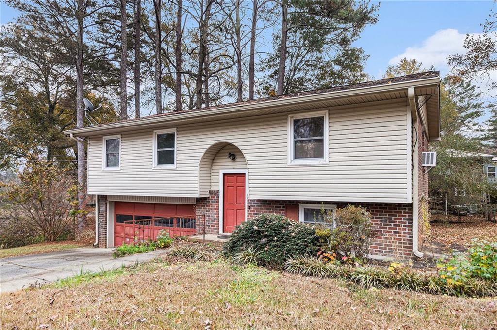 91 Berlin Street Tallapoosa, GA 30176 - Photo 2 of 25 a front view of a house with garden