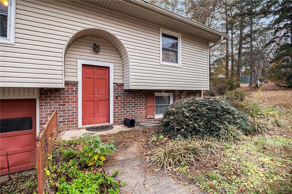 91 Berlin Street Tallapoosa, GA 30176 - Photo 4 of 25 a front view of a house with garden