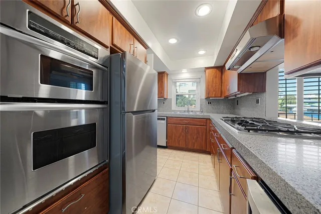 a kitchen with stainless steel appliances granite countertop a sink and a cabinets