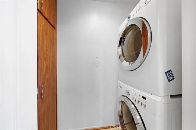 an empty room with wooden floor and ceiling fan