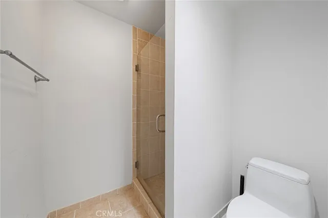 a bathroom with a shower and toilet