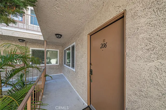 a view of empty room with wooden floor and fireplace