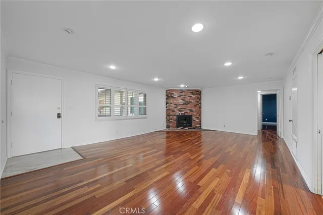 wooden floor in an empty room with a fireplace