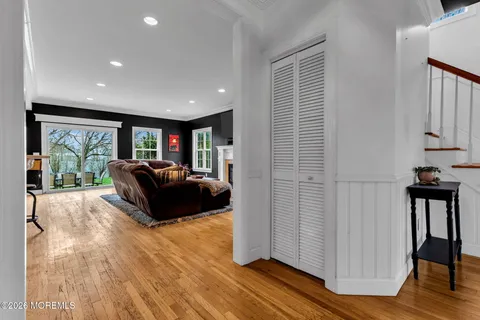 a living room with furniture fireplace and large windows