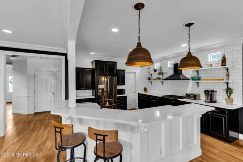 a kitchen with kitchen island a counter top space and stainless steel appliances