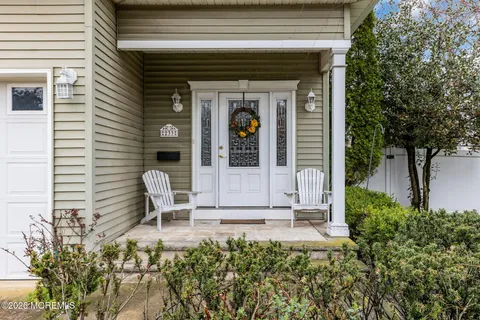 a view of an entryway with wooden floor and windows