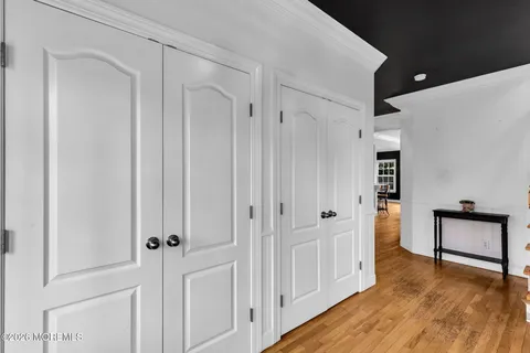 a view of entryway and hall with wooden floor