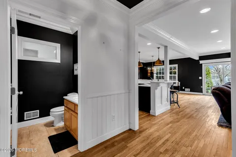 a bathroom with a granite countertop sink toilet and mirror