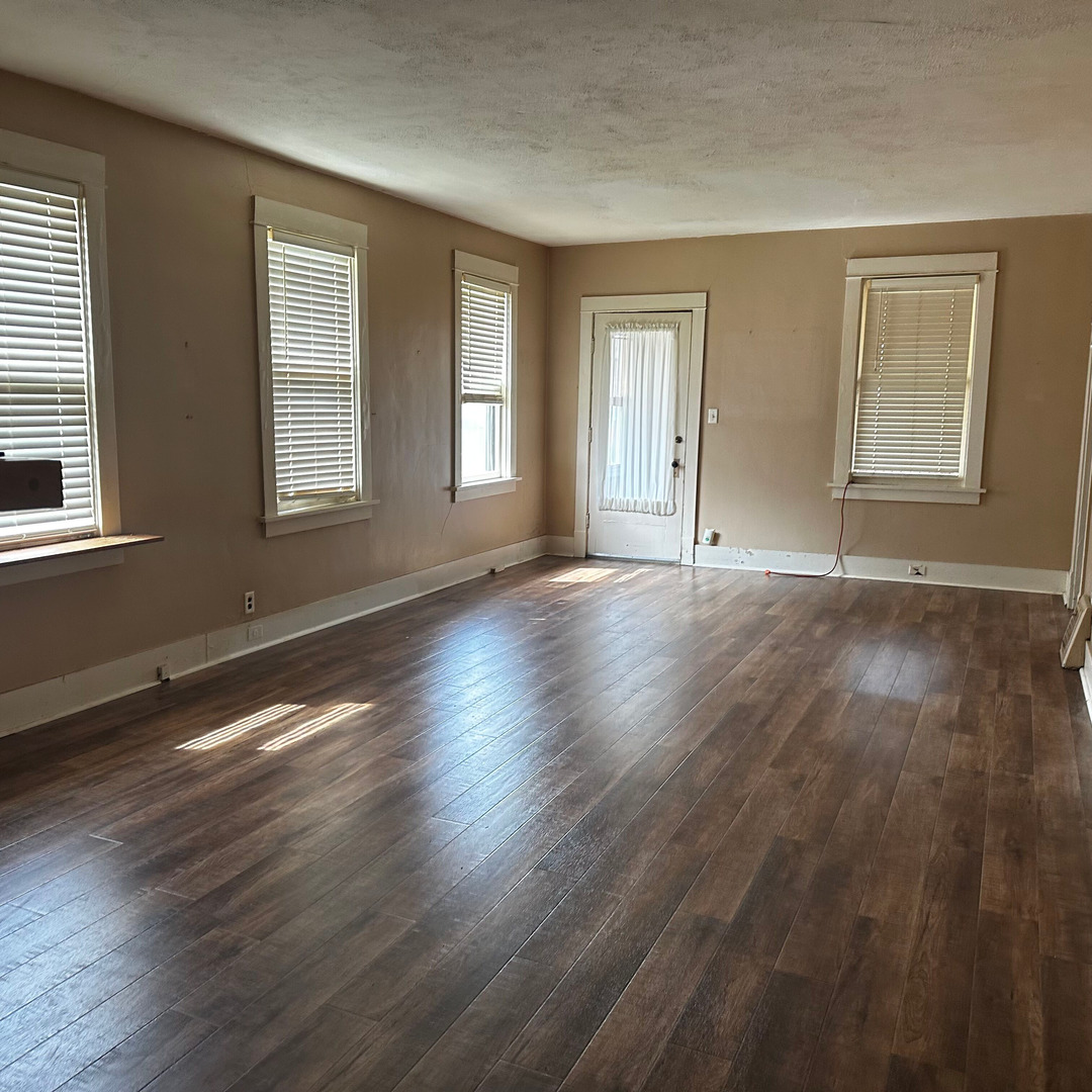 408 Marcy Street Ottawa, IL 61350 - Photo 11 of 25 a view of an empty room with wooden floor and windows
