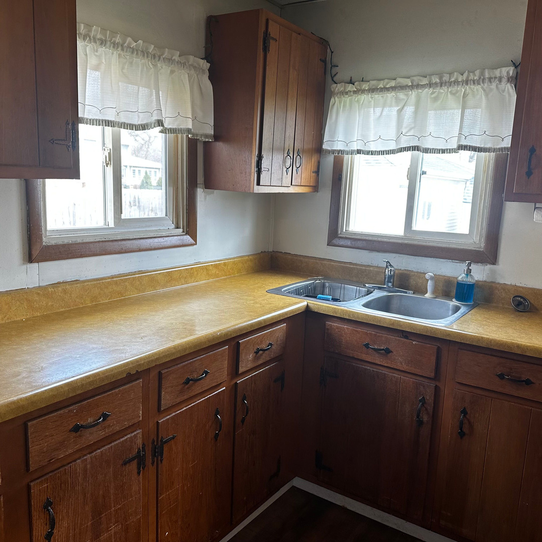 408 Marcy Street Ottawa, IL 61350 - Photo 6 of 25 a kitchen with a sink window and cabinets