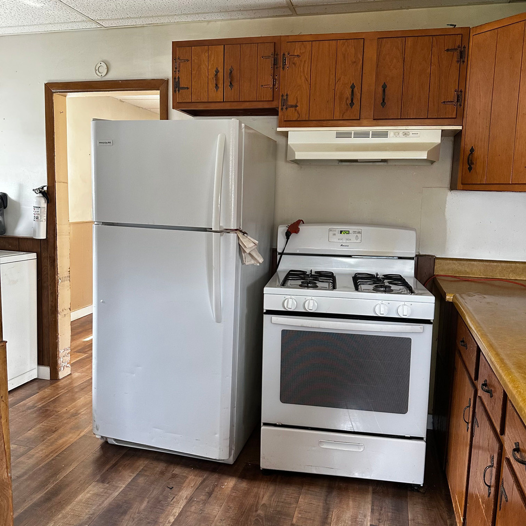 408 Marcy Street Ottawa, IL 61350 - Photo 8 of 25 a white refrigerator freezer sitting inside of a kitchen with stainless steel appliances wooden floor
