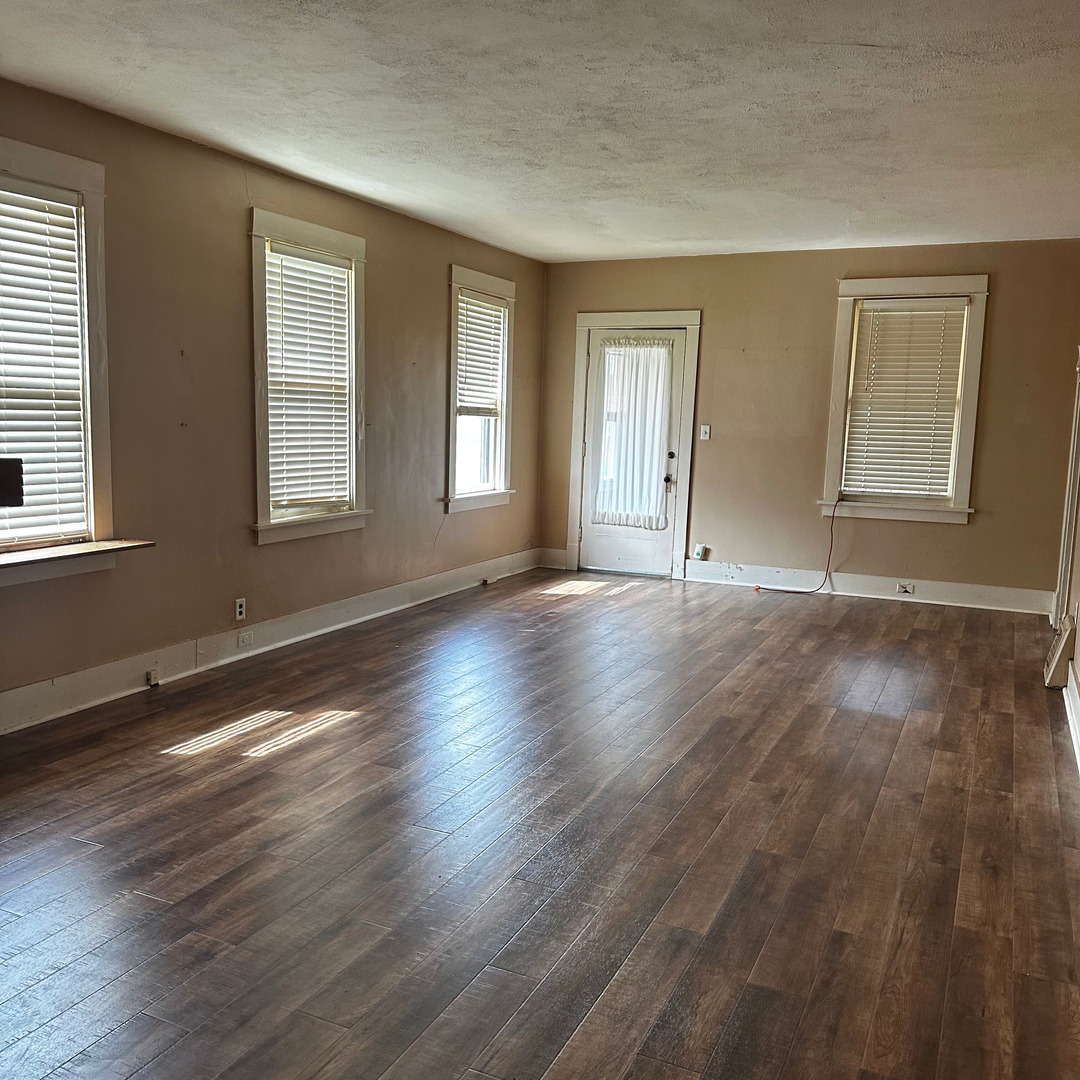 408 Marcy Street Ottawa, IL 61350 - Photo 10 of 25 a view of an empty room with wooden floor and windows